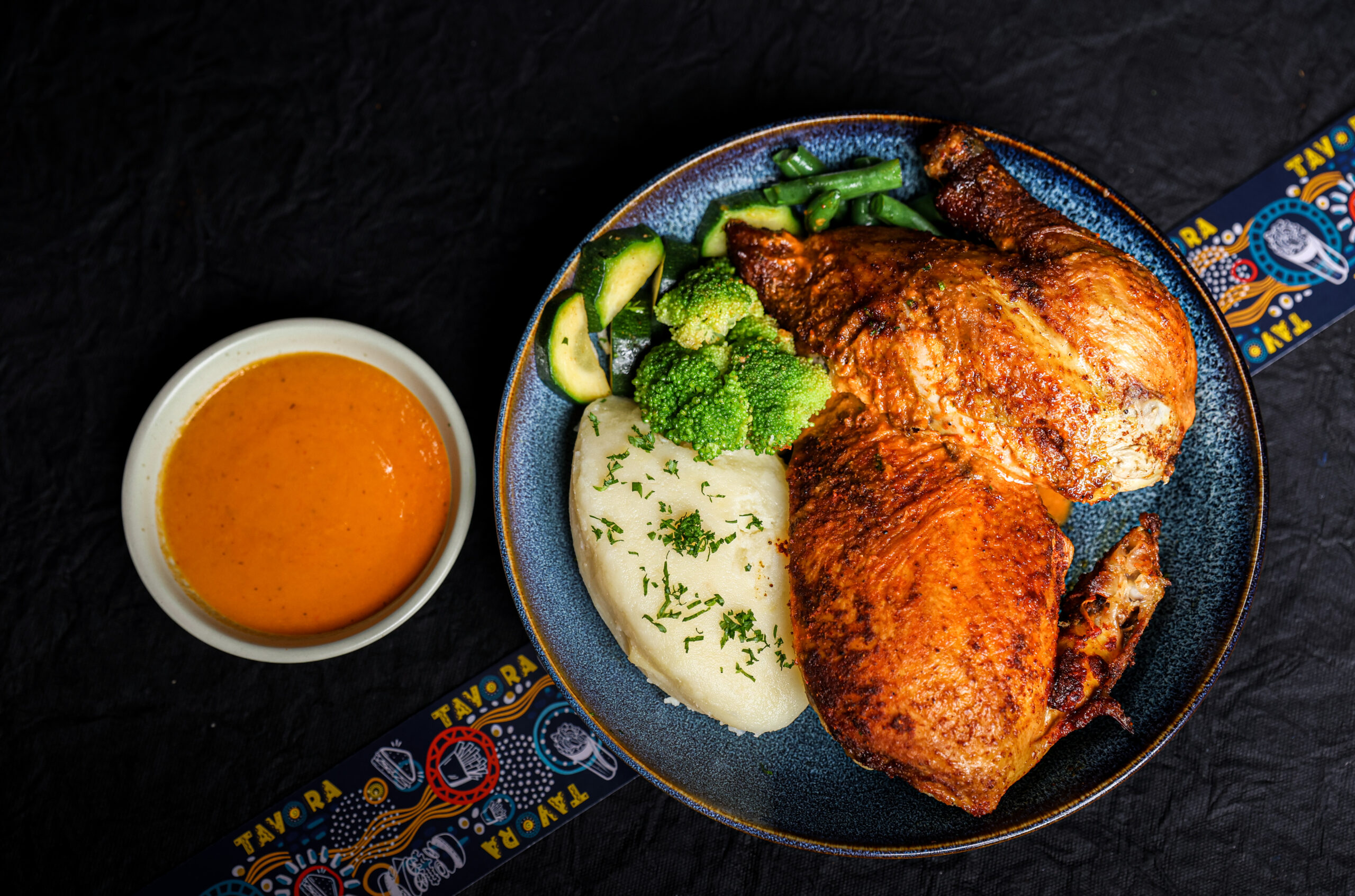 African Rub Smoked Half Chicken Bowl with mashed potatoes, vegetables and West African pepper sauce – Tavora