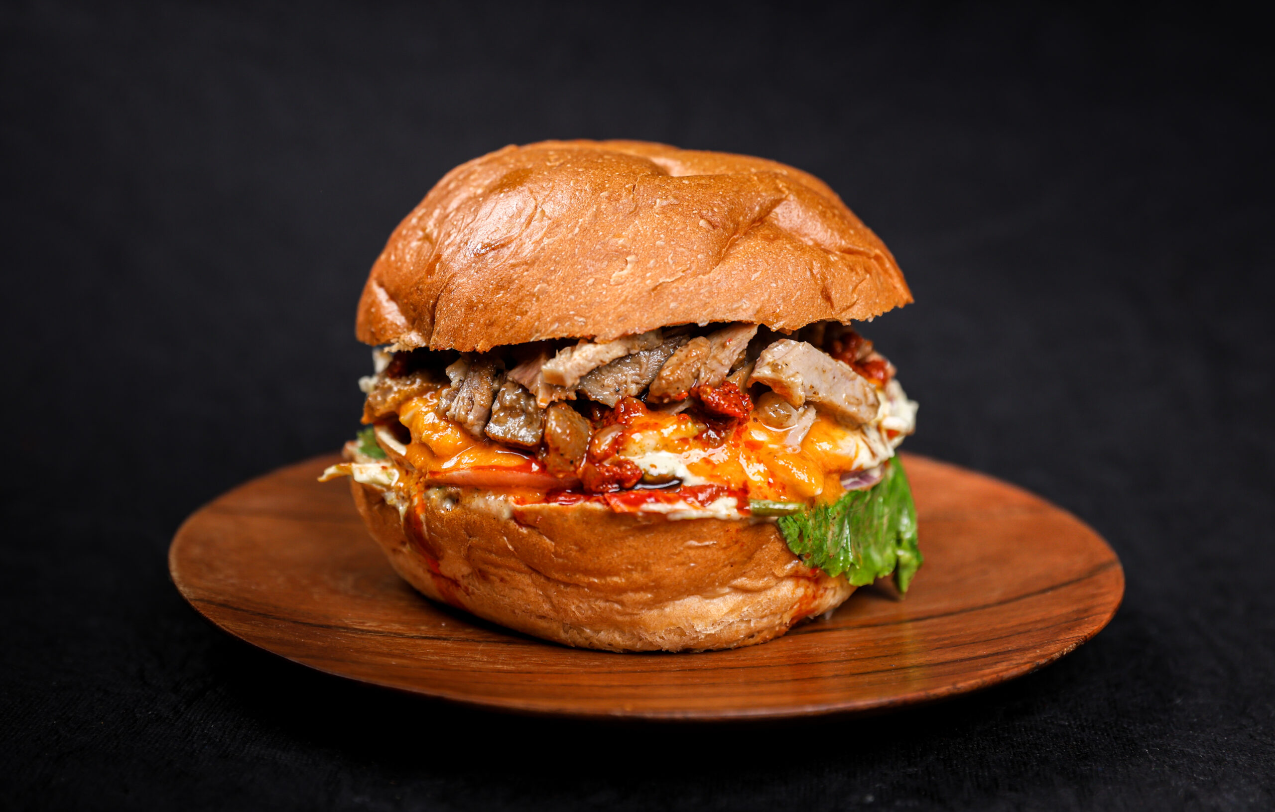 12-Hour Smoked Pulled Pepper Pork Burger with African pepper sauce, parmesan cheese and apple slaw – Tavora