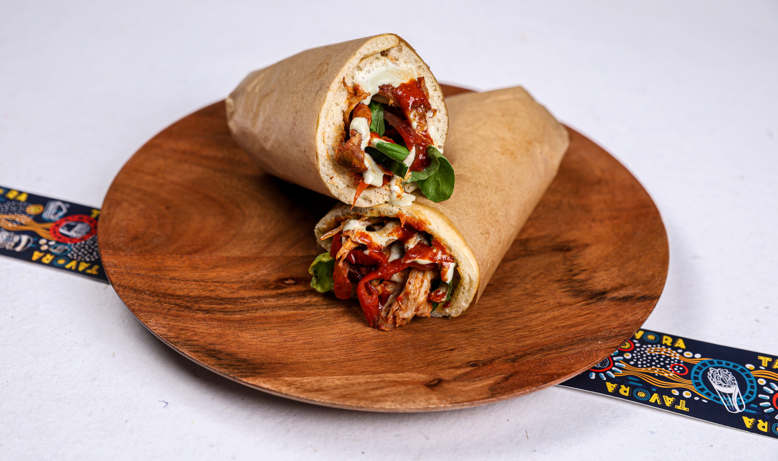 The Sizzlin Sahara Smoked Harissa Chicken Wrap with roasted bell pepper, pickled onions and mint Greek yogurt – Tavora