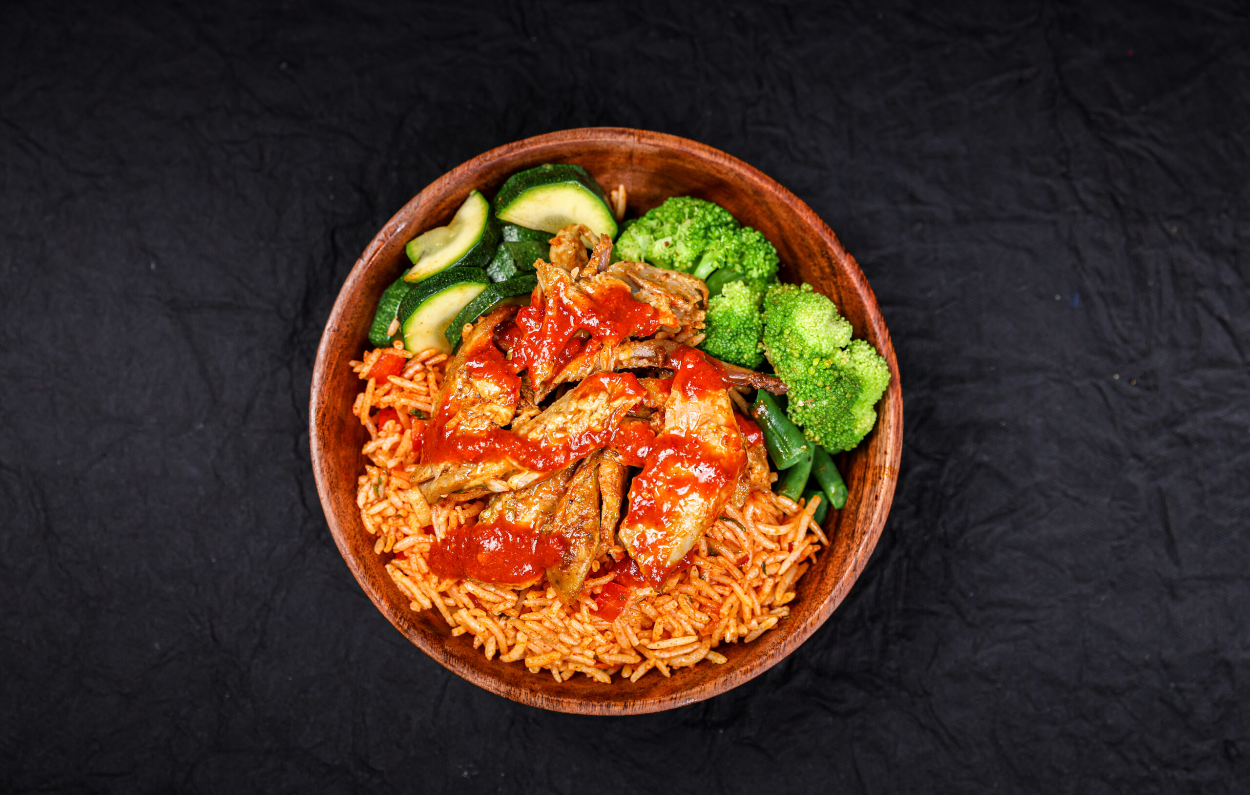 Smoked Berbere Chicken with Jollof Rice Bowl with vegetables and harissa sauce – Tavora Cloud Kitchen