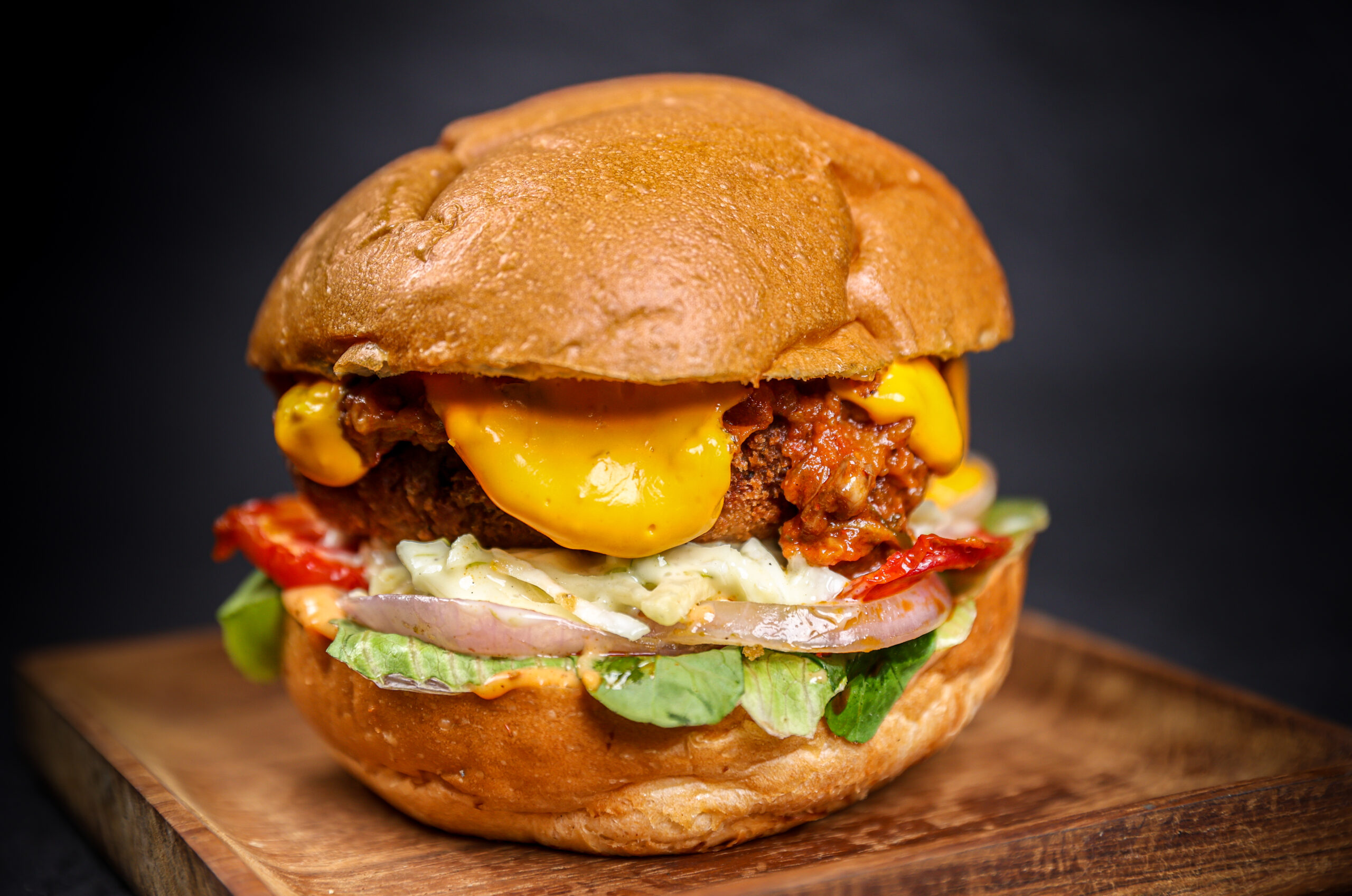 Swiss Cheese Vegetable Melt Burger with smoked vegetable patty and Zaalouk spread – Tavora