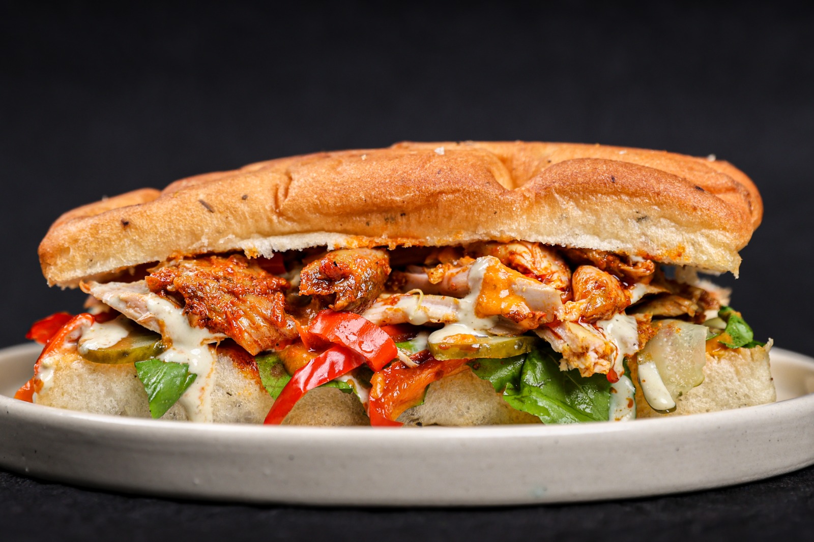 Berbere Rub Smoked Chicken Foccacia Sandwich with olive jalapeno mayo, roasted peppers and pepper sauce – Tavora Bandra West