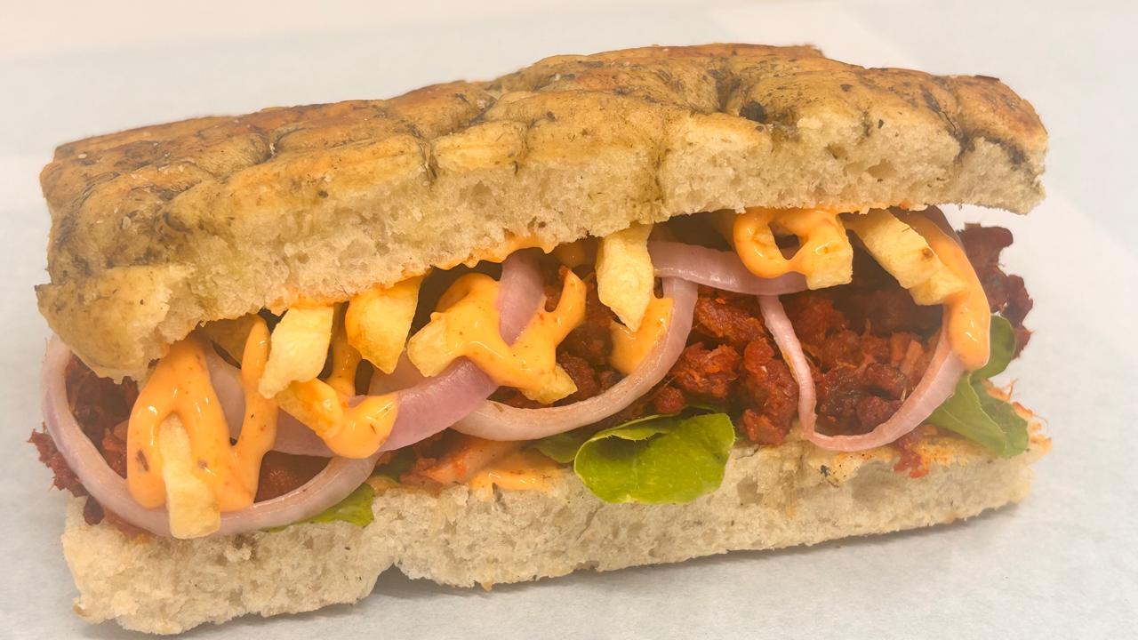 Goan Smoked Choriz Sausage Foccacia Sandwich with tomatoes, onions, green chilli and Goan masala – Tavora Cloud Kitchen