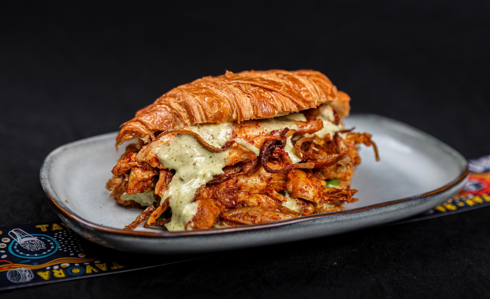 Smoked Tandoori Chicken Croissant Sandwich with mint mayo, crispy onions and rocket leaves – Tavora